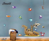 Kids wall sticker designs of underwater scene with pirate ship and big eyed fish.